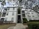 A charming condo building featuring well-maintained landscaping and inviting stairwell access at 2740 Maitland Crossing Way # 2-303, Orlando, FL 32810