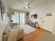 Bright living room with vaulted ceiling, laminate floors, balcony access, and stylish decor at 2740 Maitland Crossing Way # 2-303, Orlando, FL 32810