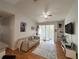 Inviting living room with laminate floors, comfortable seating, and access to a private balcony at 2740 Maitland Crossing Way # 2-303, Orlando, FL 32810