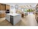Open concept kitchen features large island, modern appliances, and seamless flow to living and dining areas at 2752 Fiddle Leaf Lp Ave, Apopka, FL 32712
