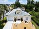 An aerial view of the property featuring a well-manicured lawn, tile roof, solar panels, and a two-car garage at 3211 Sunrise Walk, Kissimmee, FL 34747