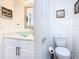 Modern bathroom with a glass bowl sink and an adjacent toilet at 3211 Sunrise Walk, Kissimmee, FL 34747