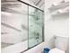 Modern bathroom features a shower with marble surround, and a toilet with convenient storage shelves at 3211 Sunrise Walk, Kissimmee, FL 34747