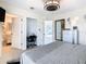 Bedroom with gray bedding, ceiling fan, dresser with wall mirror, an adjoining office and a bathroom at 3211 Sunrise Walk, Kissimmee, FL 34747