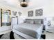 Spacious bedroom with gray bedding, decorative pillows, a ceiling fan, and stylish decor at 3211 Sunrise Walk, Kissimmee, FL 34747