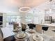 Bright dining room is adjacent to the kitchen and features a modern table setting and a large window at 3211 Sunrise Walk, Kissimmee, FL 34747