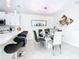 Dining area is adjacent to kitchen and features a glass top table and stylish chairs at 3211 Sunrise Walk, Kissimmee, FL 34747