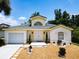 Charming single-story home featuring landscaped yard, manicured shrubs, light exterior, and a well-maintained lawn at 3211 Sunrise Walk, Kissimmee, FL 34747