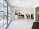 Open-concept living area showcasing a modern kitchen, dining area, and seamless access to the outdoor pool area at 3211 Sunrise Walk, Kissimmee, FL 34747