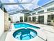Beautiful, screened-in pool and hot tub area, with plenty of lounge space and comfortable seating at 3211 Sunrise Walk, Kissimmee, FL 34747