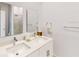 Bathroom featuring double sinks and vanity, as well as shower with glass door at 359 Famagusta Dr, Davenport, FL 33896