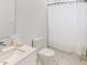 Clean bathroom featuring a shower with a curtain, toilet, and sink with a white vanity at 359 Famagusta Dr, Davenport, FL 33896
