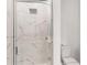 A glass shower door reveals marble tile and a showerhead at 359 Famagusta Dr, Davenport, FL 33896