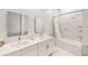 Bathroom featuring double sinks and vanity, as well as tub/shower combo with marble tiling at 359 Famagusta Dr, Davenport, FL 33896