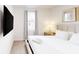 Bright bedroom with a queen bed, bedside table, and flat-screen TV for a comfortable stay at 359 Famagusta Dr, Davenport, FL 33896