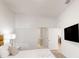 A well-lit bedroom features a TV, king bed, and en-suite bathroom and doorway to another room at 359 Famagusta Dr, Davenport, FL 33896