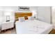 A well-lit bedroom with a plush king bed, modern nightstands, and a pristine white bathroom at 359 Famagusta Dr, Davenport, FL 33896
