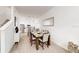 Bright open space featuring a dining table and chairs, open to a kitchen with modern appliances at 359 Famagusta Dr, Davenport, FL 33896