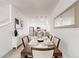 An open dining room with a dining table and seating for six is open to the modern kitchen space at 359 Famagusta Dr, Davenport, FL 33896