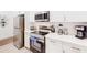 Modern kitchen with stainless appliances, white countertops, and cabinetry offering plenty of storage space at 359 Famagusta Dr, Davenport, FL 33896