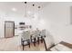 Bright kitchen boasts modern white cabinets, stainless appliances, and a breakfast bar with pendant lighting at 359 Famagusta Dr, Davenport, FL 33896