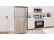 Well-lit kitchen featuring stainless steel appliances, sleek white cabinetry, and a convenient layout at 359 Famagusta Dr, Davenport, FL 33896