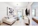 Inviting living room with a stylish sofa, contemporary art, and an open floor plan leading to a bedroom at 359 Famagusta Dr, Davenport, FL 33896