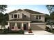 New construction two-story home featuring a two car garage and a covered front entryway at 451 Lemongrass Rd, Minneola, FL 34715