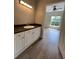 Bathroom features white cabinets with a dark countertop and wood-look flooring at 5953 Westgate Dr # 1821, Orlando, FL 32835