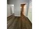 Bedroom with wood-look flooring, closet, and open bathroom door at 5953 Westgate Dr # 1821, Orlando, FL 32835