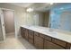 Spacious bathroom with a double sink vanity, granite countertop, and a large mirror at 6221 Argent Wood Dr, Winter Garden, FL 34787