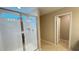 Modern shower with clear glass door and white tiled walls, complemented by a tiled floor at 6221 Argent Wood Dr, Winter Garden, FL 34787
