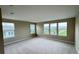 Bedroom with carpeted floors and multiple windows showing community views at 6221 Argent Wood Dr, Winter Garden, FL 34787