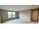 Bright bedroom featuring neutral paint, carpet flooring, and double windows offering picturesque views at 6221 Argent Wood Dr, Winter Garden, FL 34787