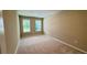 Bright, carpeted bedroom with two windows, offering natural light and a neutral color scheme at 6221 Argent Wood Dr, Winter Garden, FL 34787