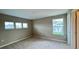 Bright bedroom with multiple windows, neutral walls, and plush carpeting, offering ample natural light at 6221 Argent Wood Dr, Winter Garden, FL 34787