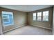 Bright bedroom with carpeting and three windows that provide ample natural light at 6221 Argent Wood Dr, Winter Garden, FL 34787