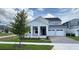 Charming two-story home with a two-car garage and inviting covered entry at 6221 Argent Wood Dr, Winter Garden, FL 34787