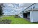 A view of the home's exterior, showcasing the backyard, covered patio, and landscaping at 6221 Argent Wood Dr, Winter Garden, FL 34787