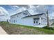 Exterior view of the two-story home with a covered patio and landscaped lawn at 6221 Argent Wood Dr, Winter Garden, FL 34787