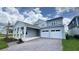 Charming home featuring a covered entryway, a two-car garage, and a paved driveway at 6221 Argent Wood Dr, Winter Garden, FL 34787