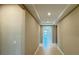 Long hallway features neutral-toned walls and tiled flooring with a recessed ceiling at 6221 Argent Wood Dr, Winter Garden, FL 34787