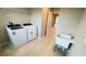 Bright laundry room equipped with a washer, dryer and utility sink at 6221 Argent Wood Dr, Winter Garden, FL 34787