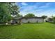Spacious backyard featuring a well-manicured lawn, patio, and privacy fencing at 654 Romano Ave, Orlando, FL 32807