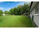 Expansive backyard featuring a well-maintained lawn, shed, and covered patio area at 654 Romano Ave, Orlando, FL 32807
