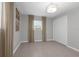 Bedroom showcases tile flooring, window, closet, neutral walls, baseboards, and modern ceiling light at 654 Romano Ave, Orlando, FL 32807