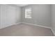Bedroom featuring tile flooring, neutral walls, window with blinds, and double door closet at 654 Romano Ave, Orlando, FL 32807