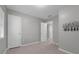 Neutral bedroom with connecting door, tile flooring, neutral walls, and double door closet at 654 Romano Ave, Orlando, FL 32807