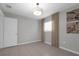 Bedroom with tile flooring, light neutral walls, door, large window with curtains, and a modern ceiling light at 654 Romano Ave, Orlando, FL 32807