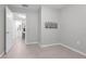 Neutral bedroom with tile flooring, decorative wall art, and connecting door to bathroom at 654 Romano Ave, Orlando, FL 32807